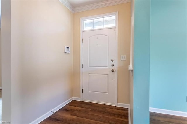 entrance foyer featuring ornamental molding, dark wood finished floors, and baseboards