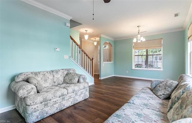 living room with wood finished floors, crown molding, baseboards, and stairs