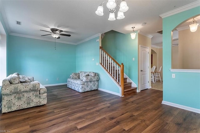 unfurnished living room featuring stairs, visible vents, arched walkways, and wood finished floors