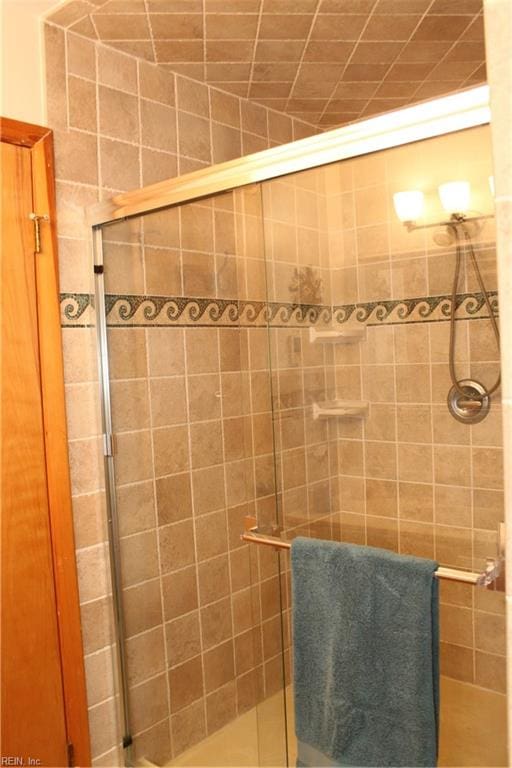 bathroom with a shower with door