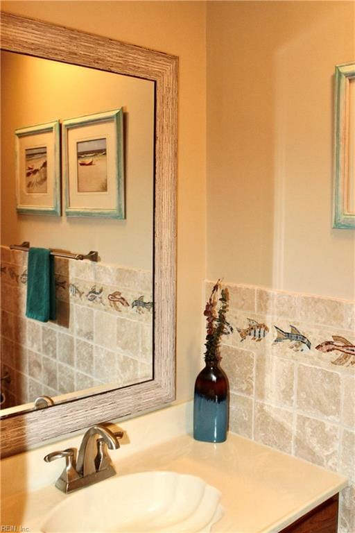 bathroom featuring vanity and tile walls