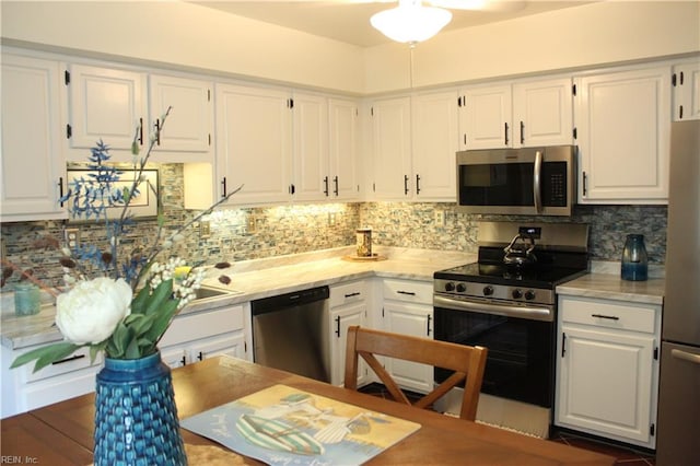 kitchen featuring white cabinetry, backsplash, sink, and appliances with stainless steel finishes