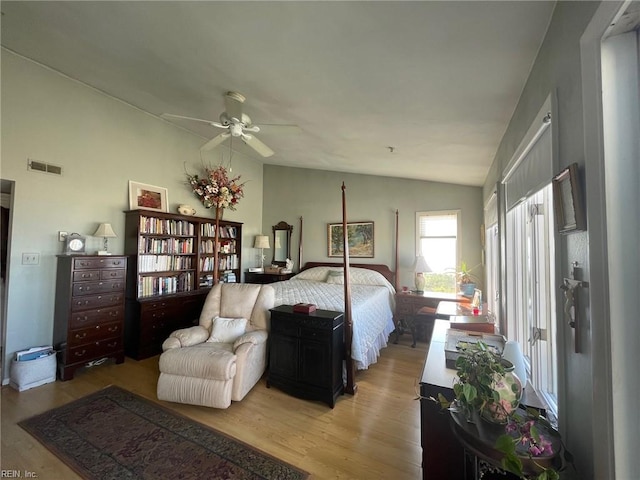 bedroom with vaulted ceiling, hardwood / wood-style floors, and ceiling fan