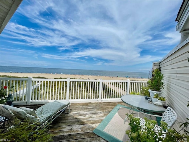 deck with a beach view and a water view