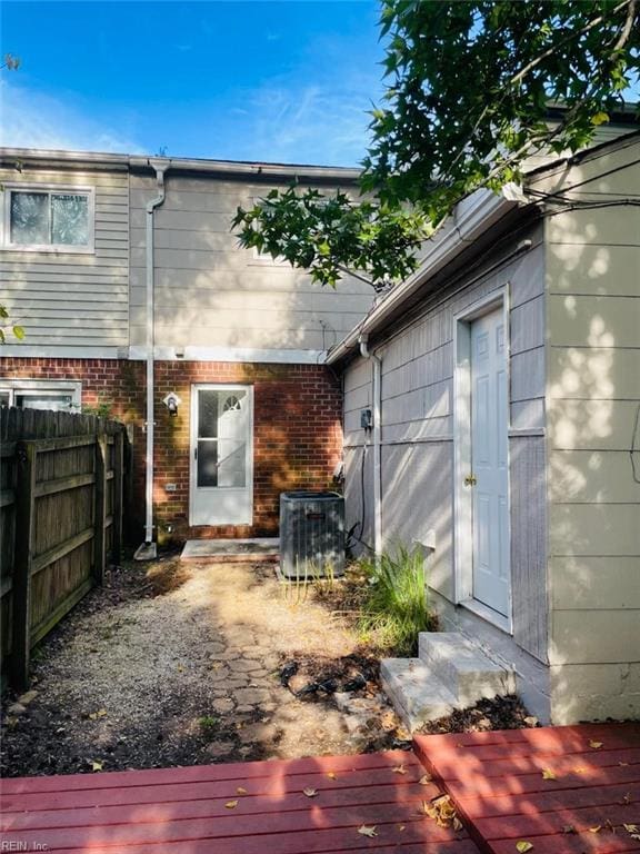 rear view of property featuring central AC