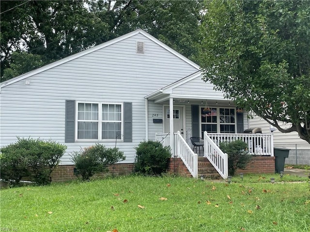 bungalow-style house with a front lawn and a porch