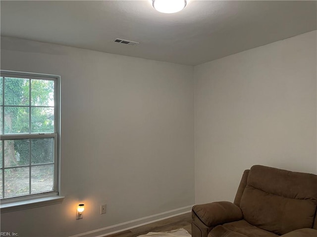 living area with hardwood / wood-style floors