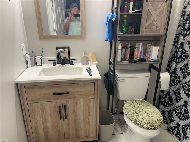 bathroom with toilet and vanity