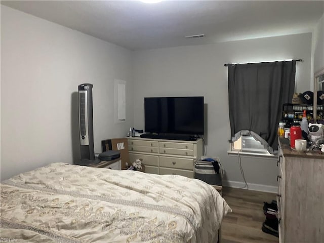 bedroom with dark hardwood / wood-style floors