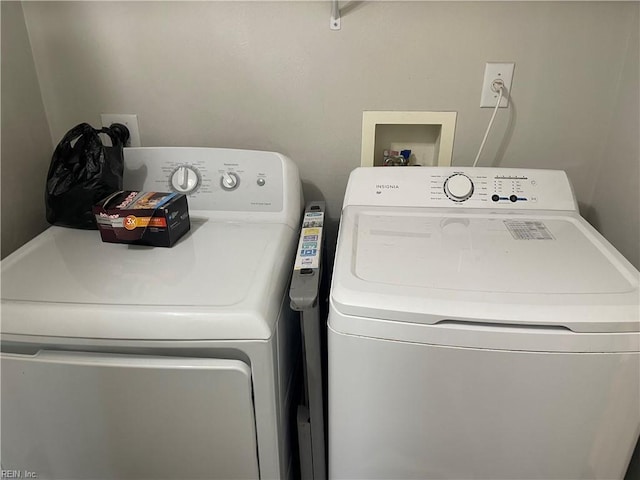 clothes washing area with washing machine and clothes dryer