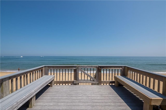 view of community featuring a view of the beach and a deck with water view