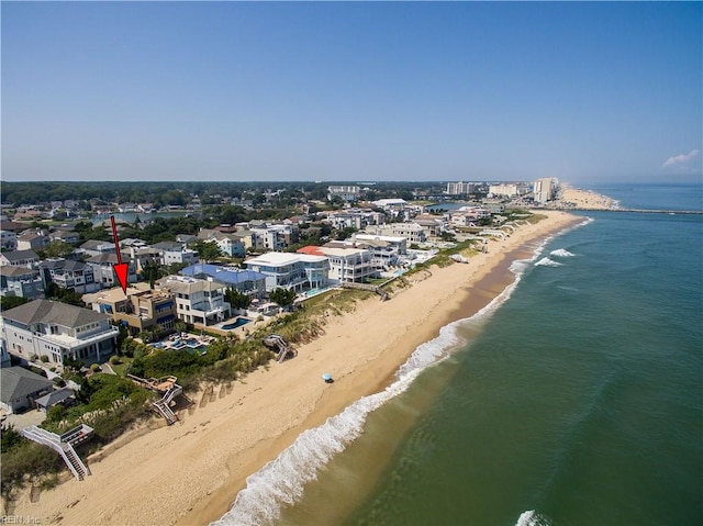 drone / aerial view featuring a beach view and a water view