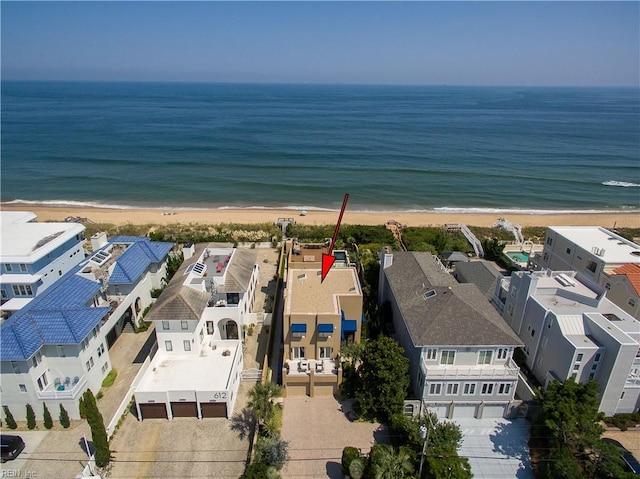 birds eye view of property featuring a water view and a beach view