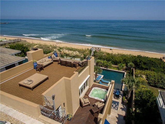 birds eye view of property featuring a water view and a beach view