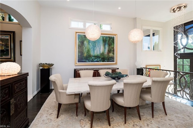 dining area with a healthy amount of sunlight and dark hardwood / wood-style flooring