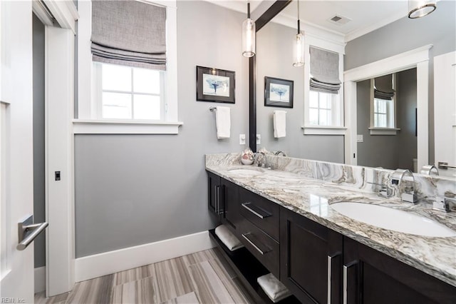 bathroom with crown molding and vanity