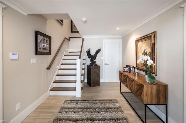 entrance foyer featuring crown molding and light wood-type flooring