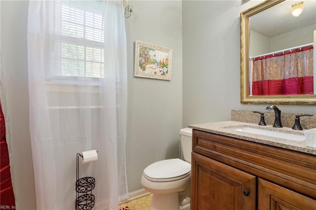 bathroom with toilet and vanity