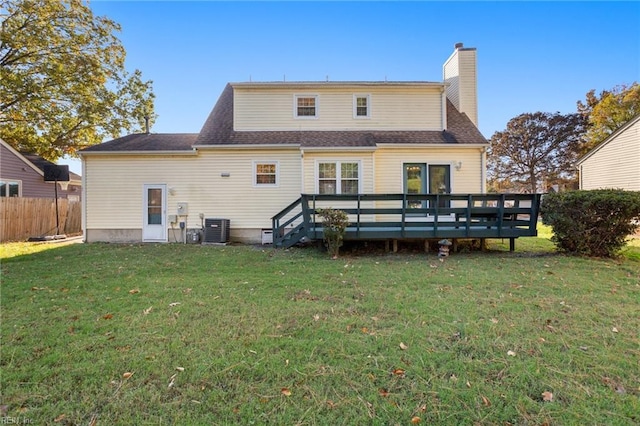 back of house featuring cooling unit, a yard, and a deck