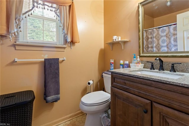 bathroom featuring toilet and vanity