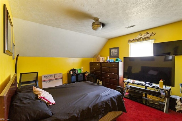 carpeted bedroom with lofted ceiling, a textured ceiling, and ceiling fan