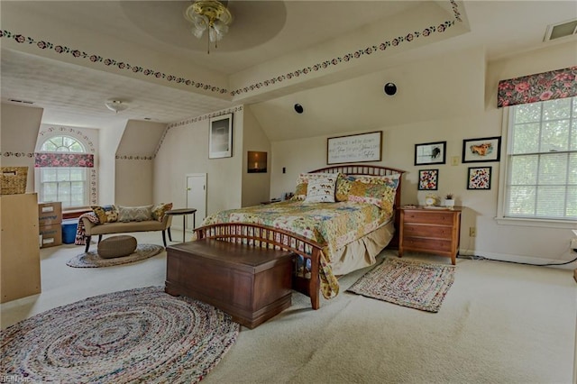 bedroom featuring lofted ceiling, carpet flooring, and visible vents