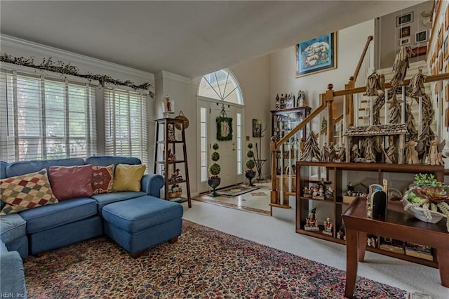 living room with stairway, ornamental molding, a wealth of natural light, and carpet floors