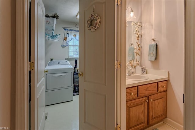 bathroom featuring washer / clothes dryer and vanity