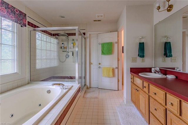 full bathroom featuring vanity, a healthy amount of sunlight, a stall shower, and a whirlpool tub