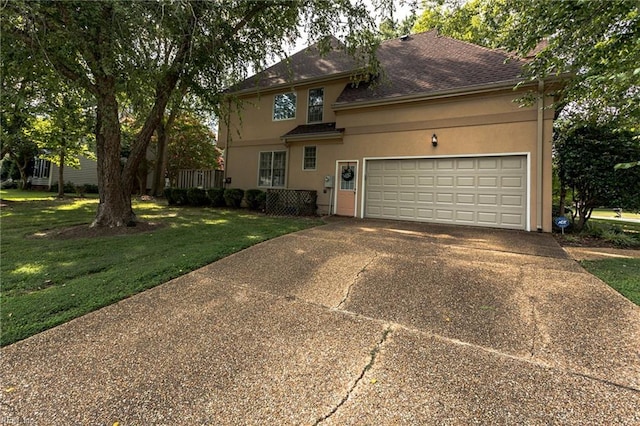 view of front of house featuring a front yard, driveway, a shingled roof, stucco siding, and a garage