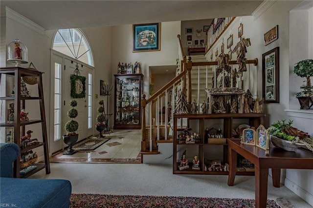 carpeted foyer entrance featuring stairs