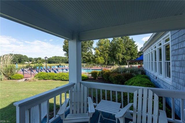 deck featuring a yard and a community pool