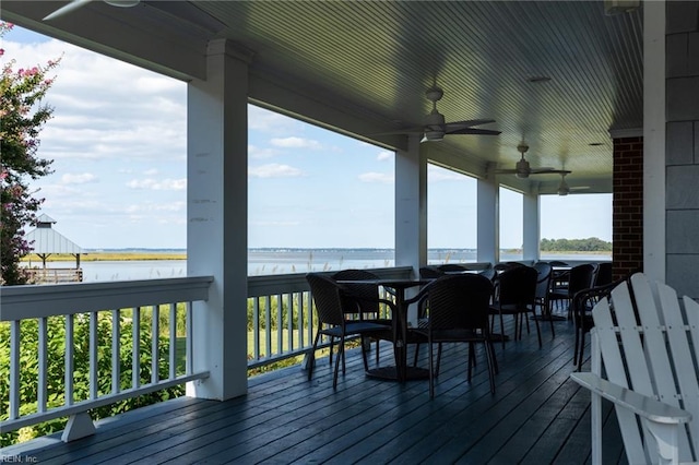 deck featuring a water view and ceiling fan