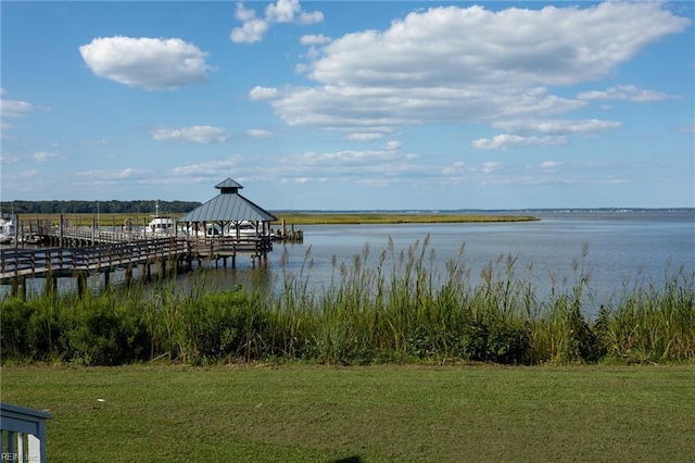 dock area with a yard and a water view