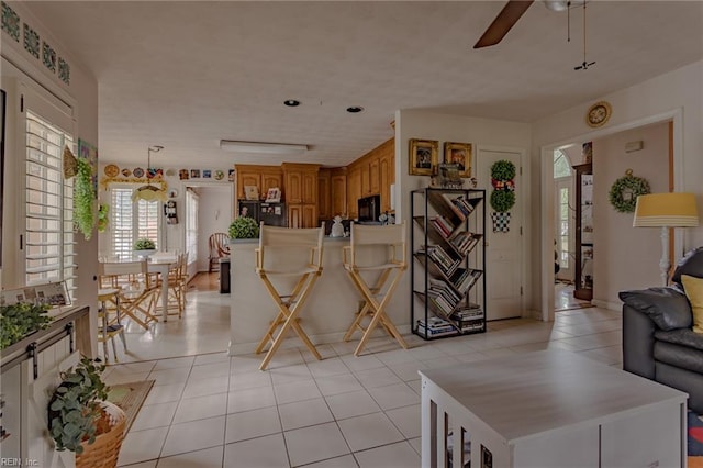 living room with light tile patterned floors and a ceiling fan