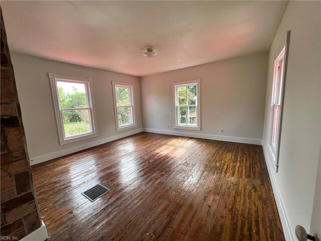 unfurnished living room featuring dark hardwood / wood-style floors