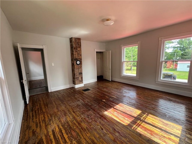 unfurnished living room with dark hardwood / wood-style flooring