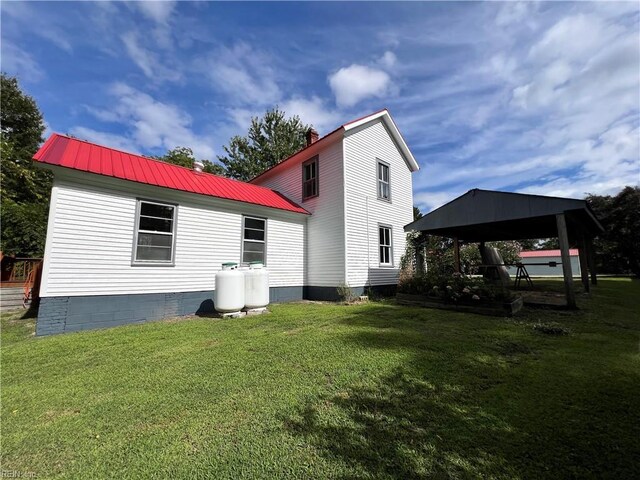 rear view of property with a yard