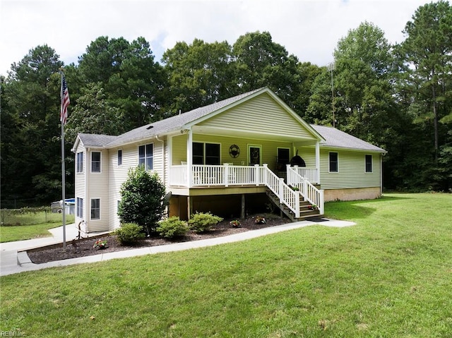 view of front of home with a front yard and covered porch