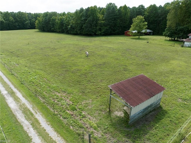 view of community featuring a lawn and a rural view