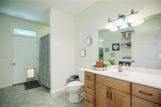 bathroom featuring walk in shower, toilet, and vanity