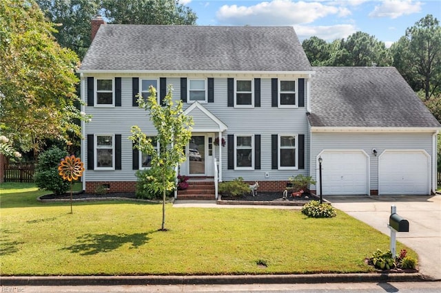 colonial house with a garage and a front lawn