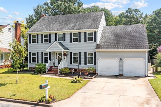 colonial inspired home featuring a garage and a front yard