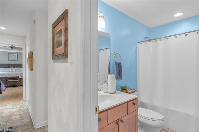 full bathroom with vanity, toilet, hardwood / wood-style flooring, shower / bathtub combination with curtain, and ceiling fan