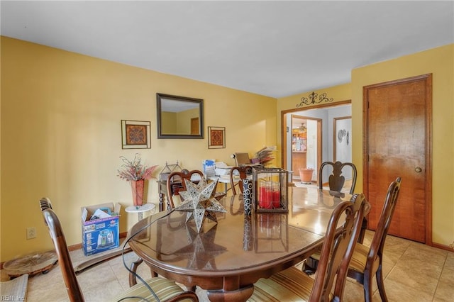 dining area featuring light tile patterned floors