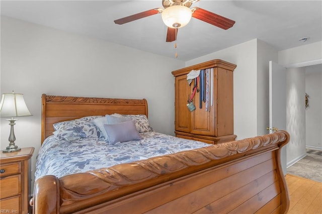 bedroom with light hardwood / wood-style flooring and ceiling fan