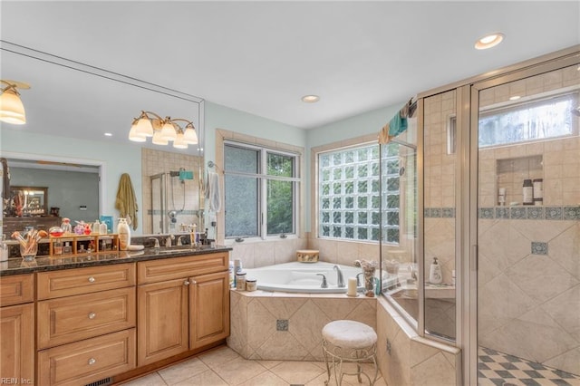 bathroom featuring vanity, independent shower and bath, and tile patterned floors