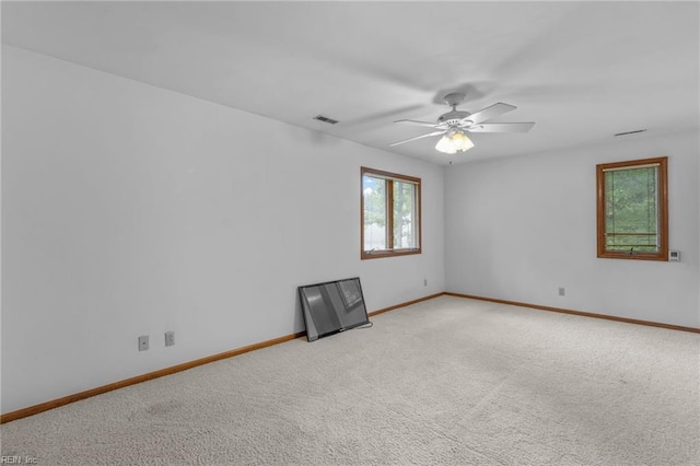 carpeted spare room with ceiling fan