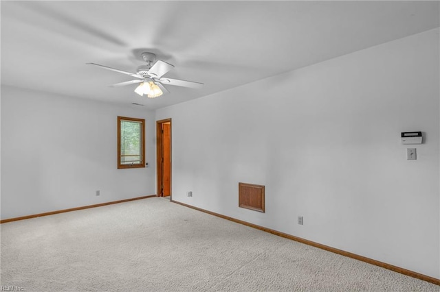 empty room featuring light carpet and ceiling fan