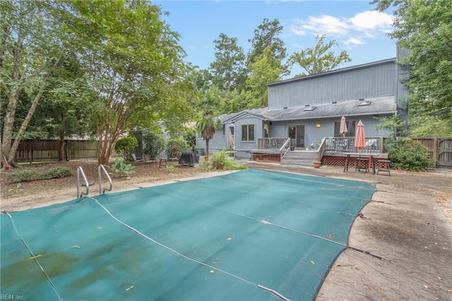 view of swimming pool with a wooden deck